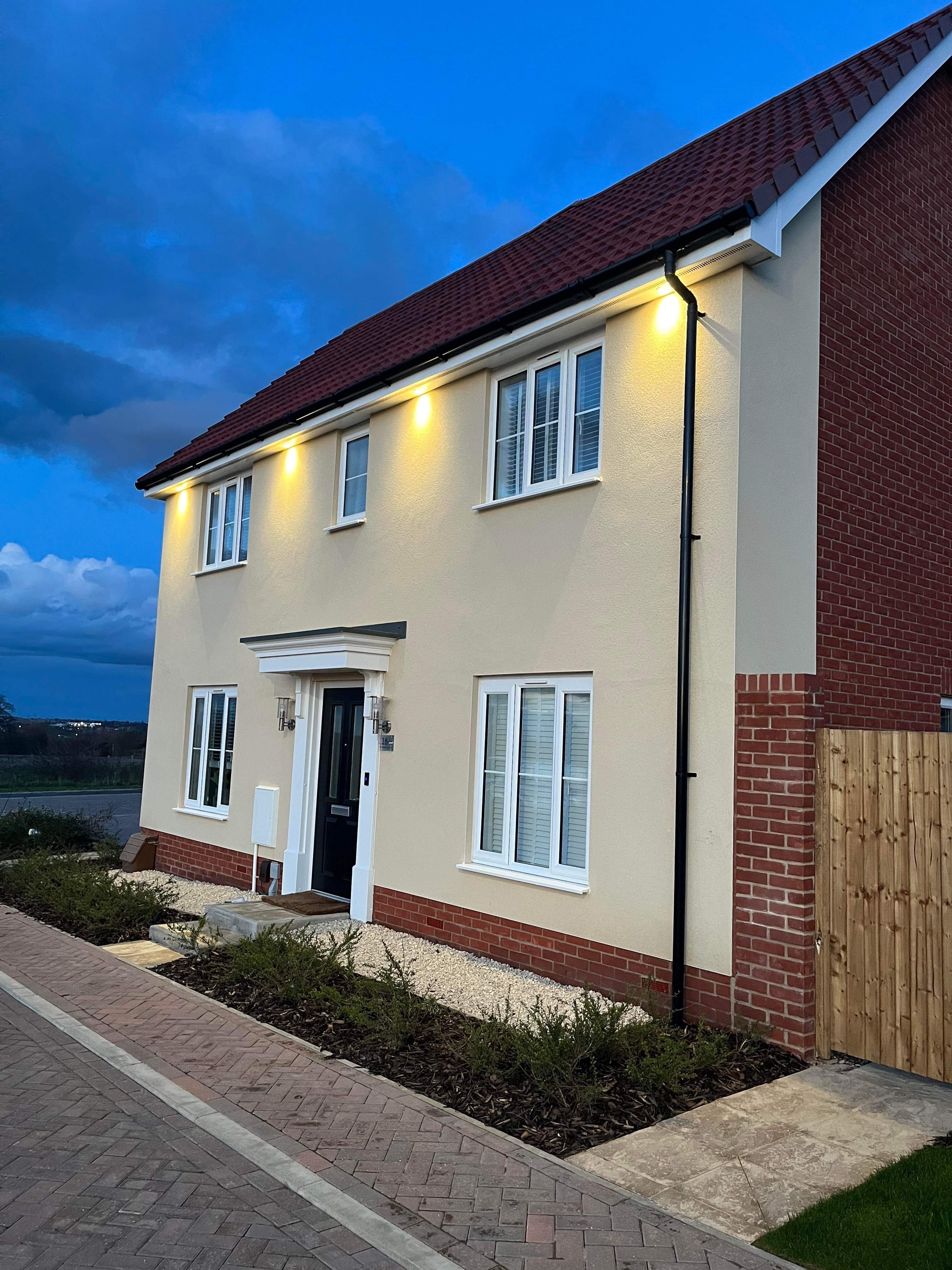 House exterior with security lighting at dusk