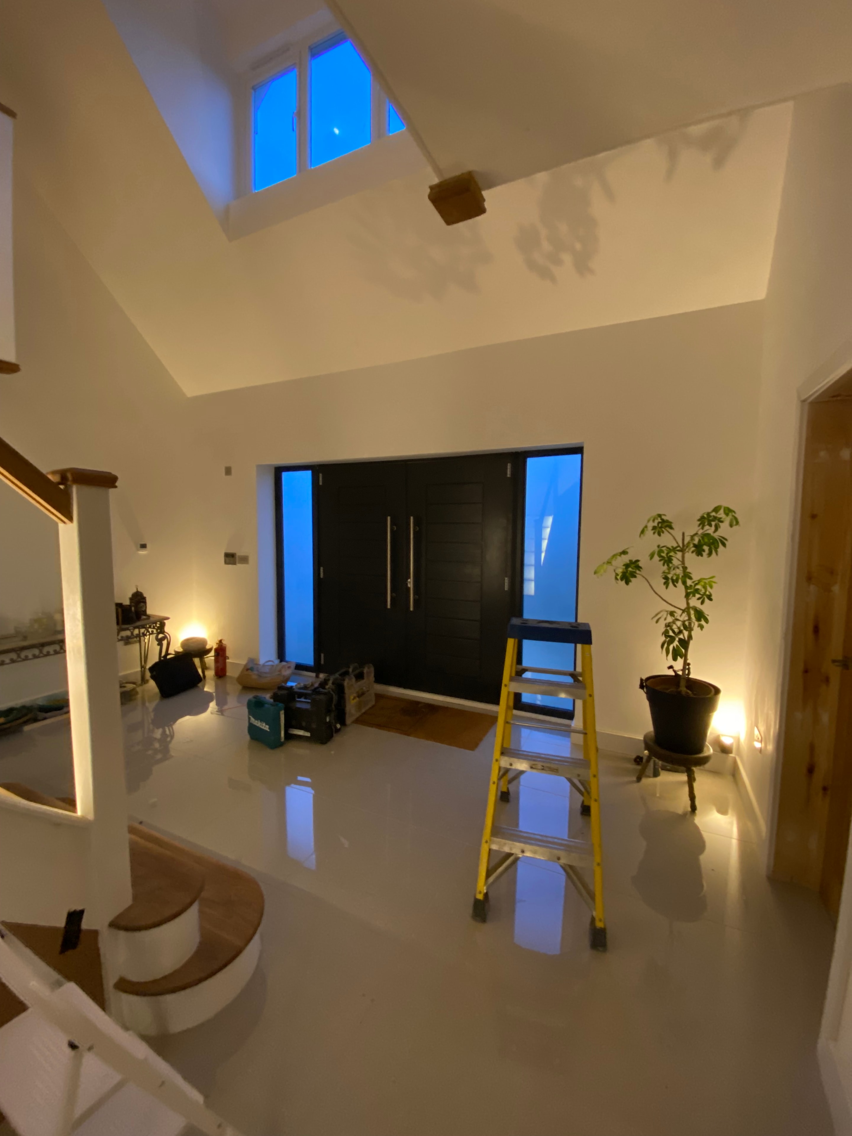 Pendant light installation in progress in open hallway