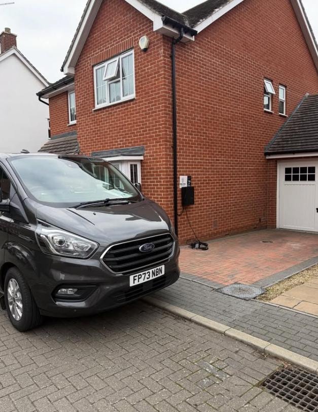 Van parked at EV charger installation